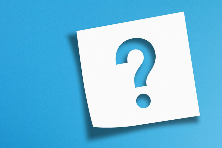Note paper with question mark on panoramic blue background